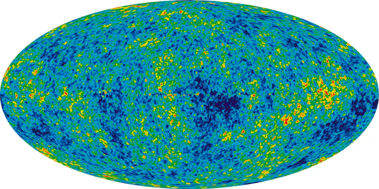 Oval image in splotches of blue, yellow and green.