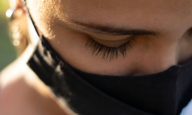 a woman's eyes above a face mask