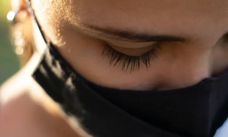 a woman's eyes above a face mask