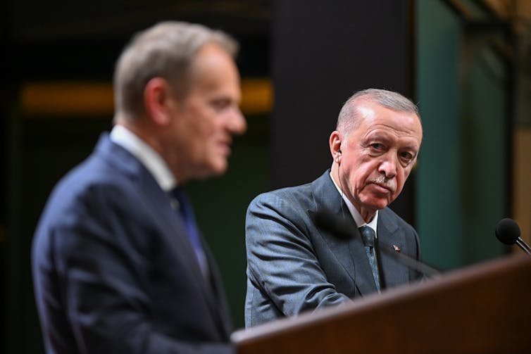 Turkey: a beneficial global local weather is spurring Erdoğan’s crackdown on democracy 1 Erdoğan looks at Polish prime minister Donald Tusk as he delivers a speech.