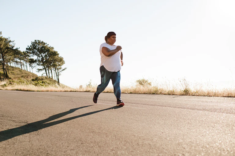 Person jogging on a country road.
