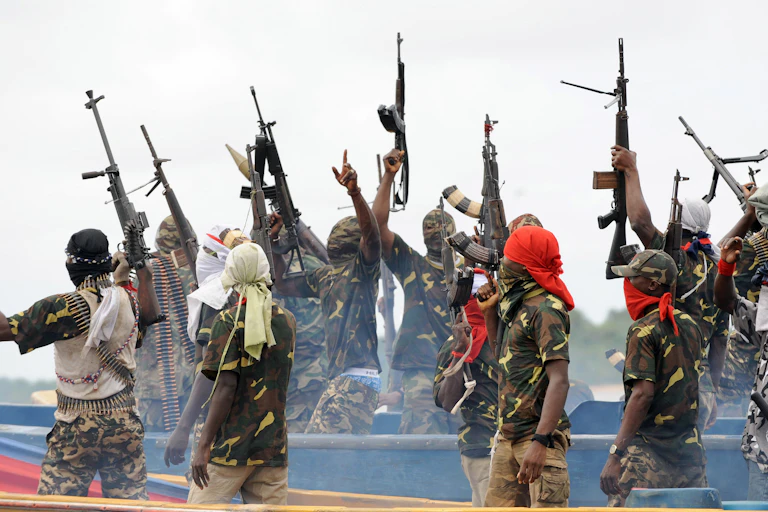 Men waving their rifles in the air in celebration