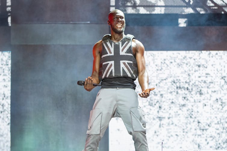 Glastonbury is as standard as ever, however proceedings in regards to the lineup disclose its generational problem 3 Black British rapper Stormzy on stage wearing a black Union Jack stab vest.