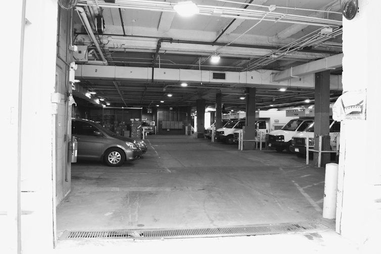 A black and white photo of a carpark