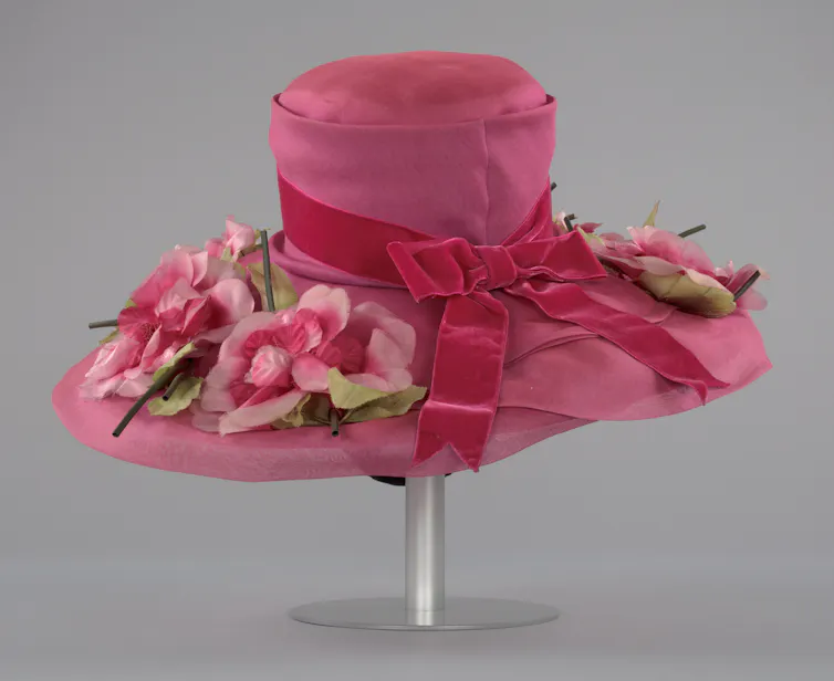 Large pink women's hat with dark pink bow and pink flowers