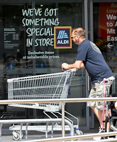 shopper out front of an ALDI store.