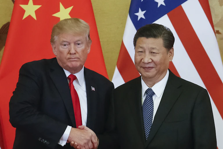 US president Donald Trump shakes hands with Chinese president Xi Jinping.