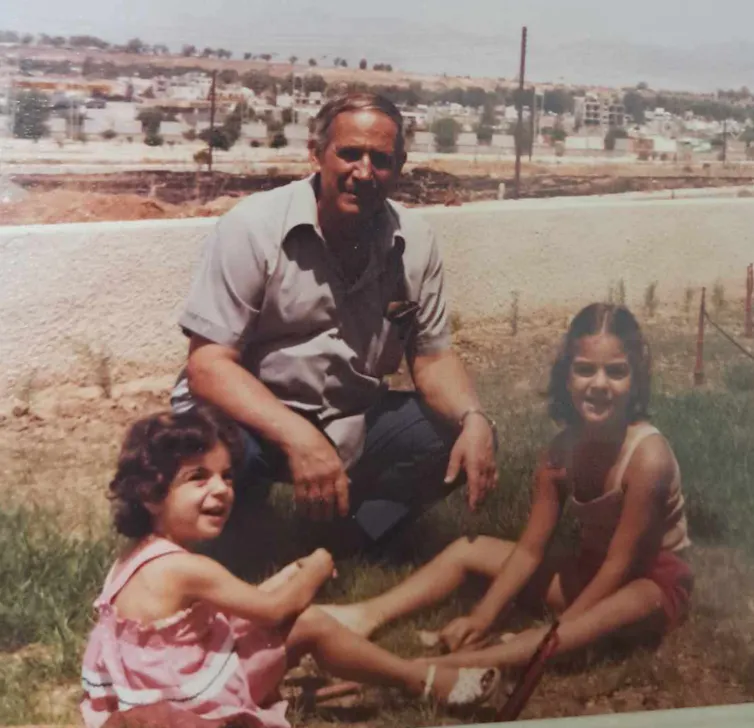 Family photo of a grandfather and two young granddaughters