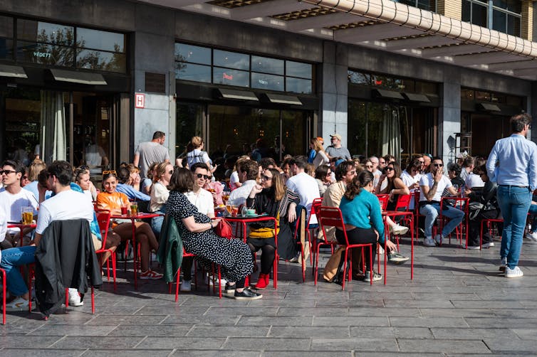 People sitting in the sun at a cafe in Belgium