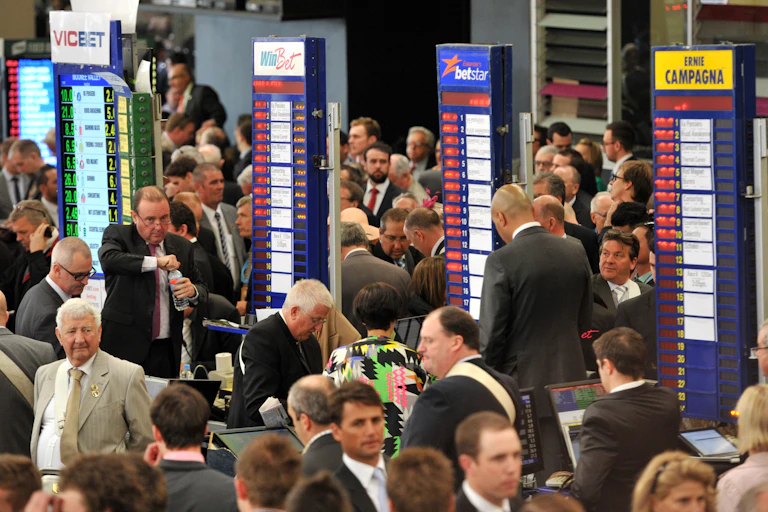 Punters line up to bet with bookies during a race day