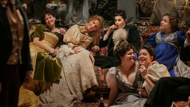 Film still: a gathering of friends at a party in 20th century France.