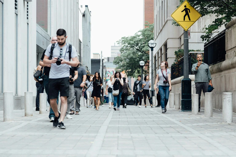 people walking down a city boulevard