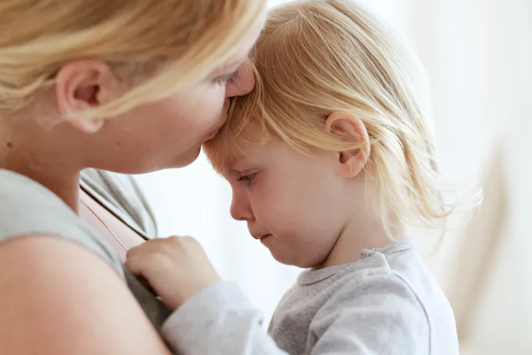 young mother kissing her toddler