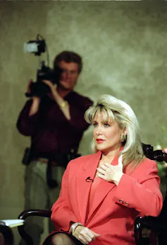 A blonde in an apricot suit.