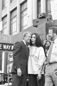 Jimmy Carter leans in to a surprised Cher.