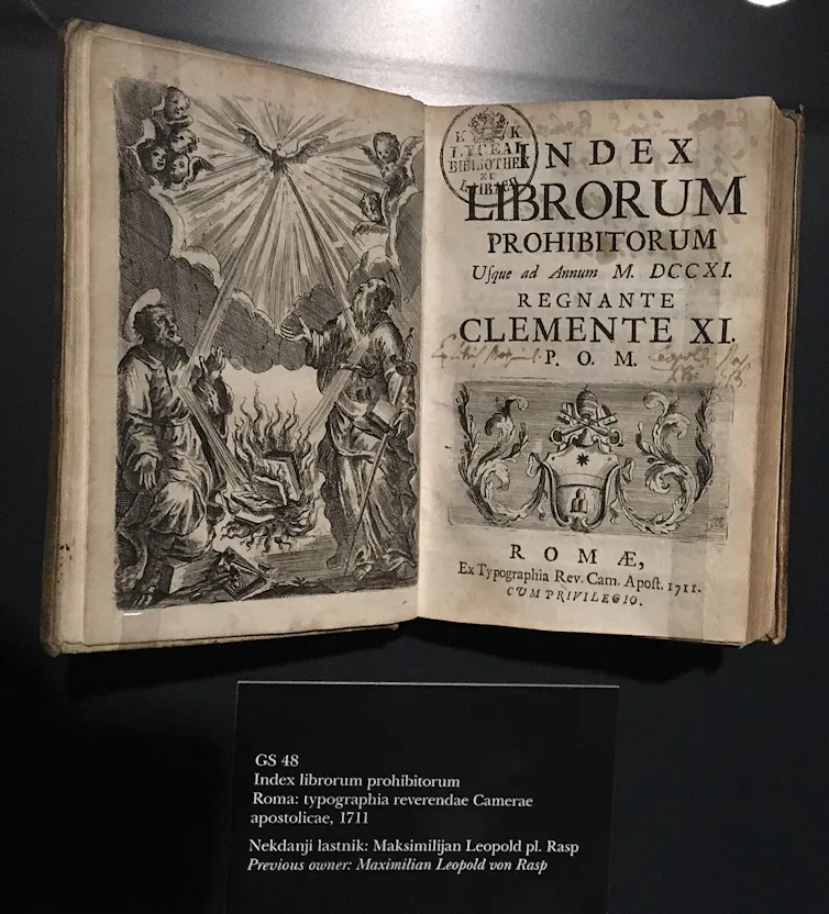 A black and white book open to a double page with large black and white illustrations.