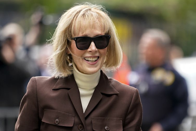 A woman with a blonde bob wearinng sunglasses.