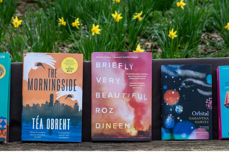 The shortlisted books in front of daffodils