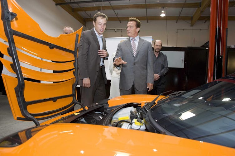 Two bros looking at a car