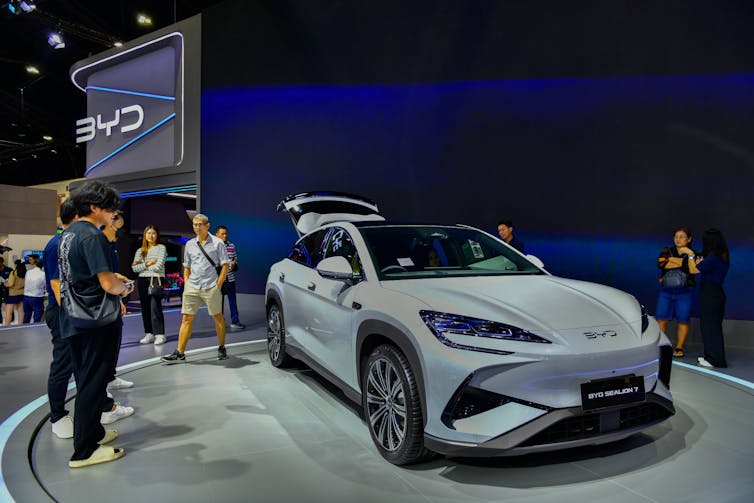 People looking at car