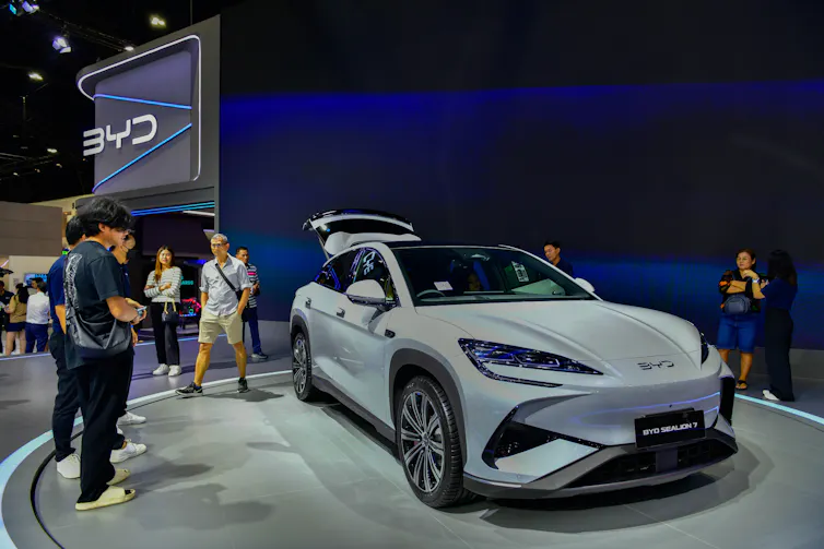 People looking at car