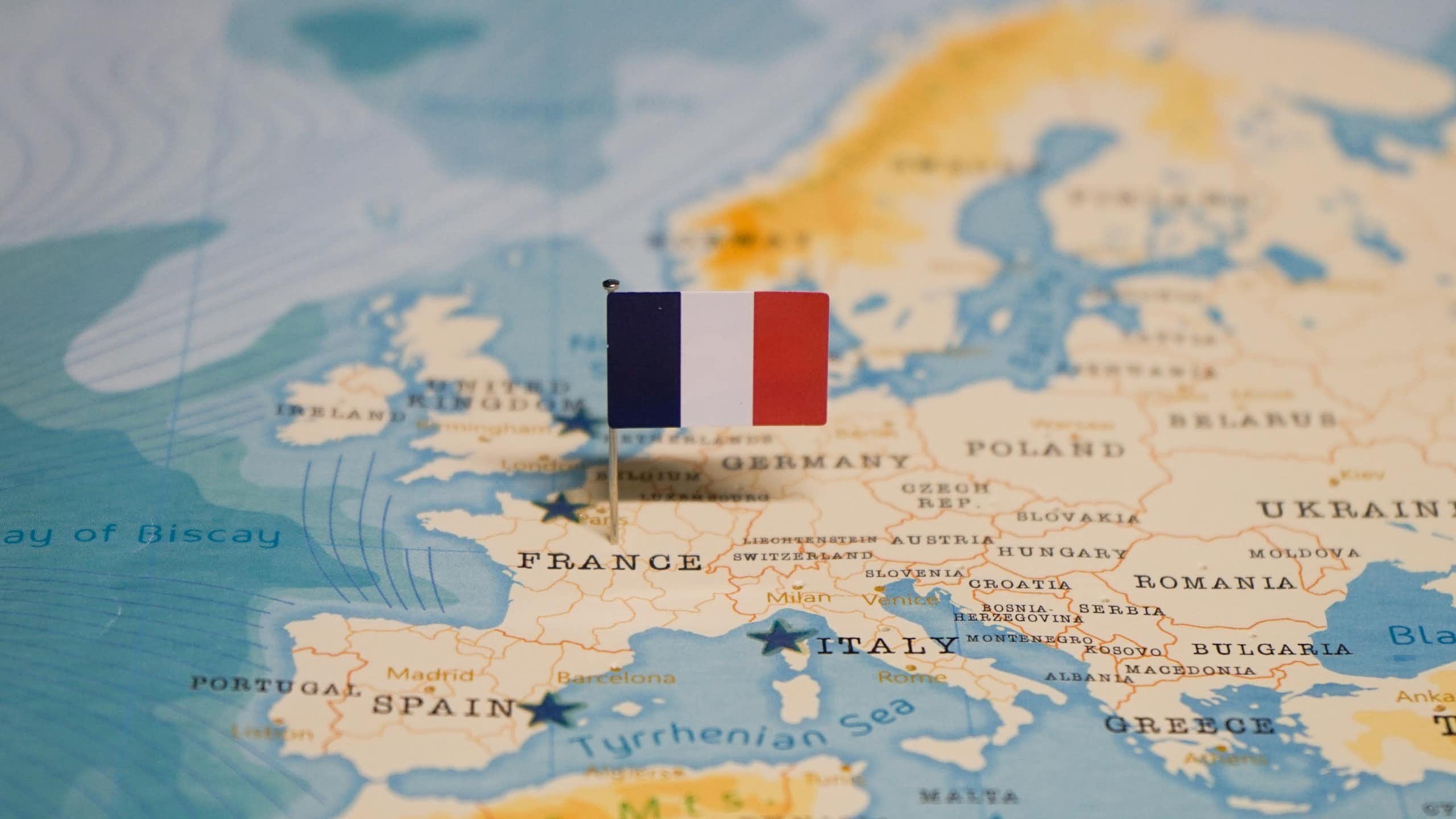 A map with a French flag pinned into France.
