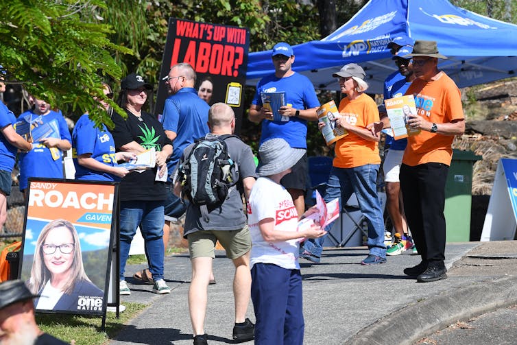 volunteers and voters outside a polling station