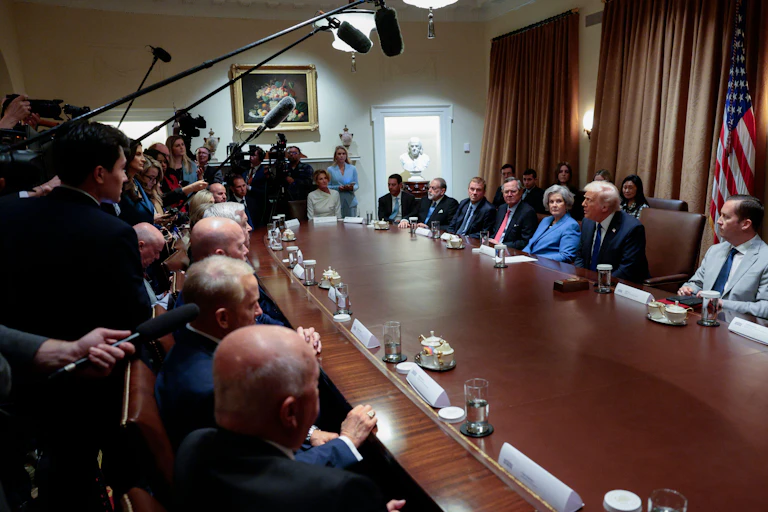 US president Donald Trump sits in the cabinet room in the White House next to his chief of staff, Susie Wils, and a group of senior officials.