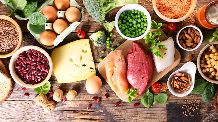 An assortment of protein sources from wohle foods, such as meat, beans, peas and nuts.