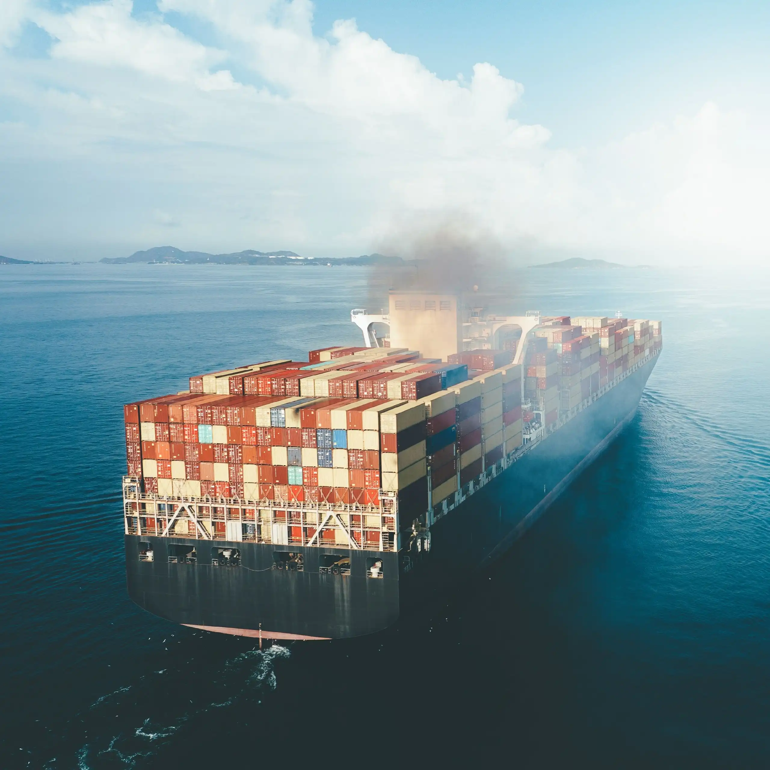 A cargo ship burning fossil fuel