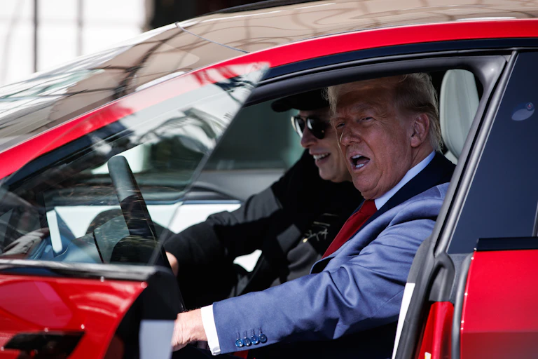 Elon Musk and Donald Trump inside a car.