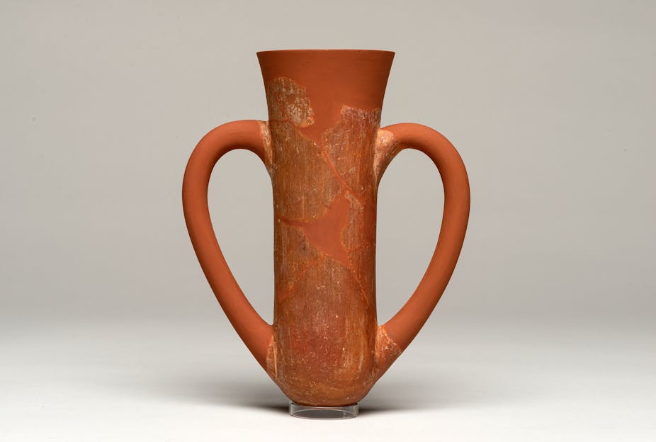 A terracota cup with two drinking handles