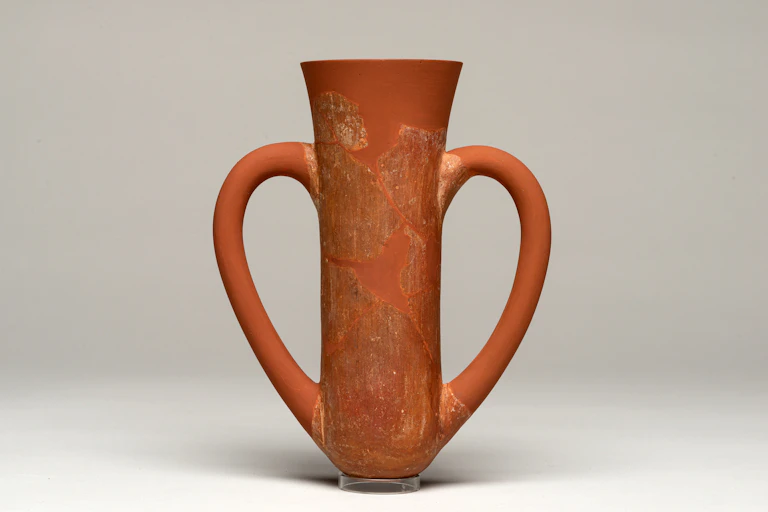 A terracota cup with two drinking handles