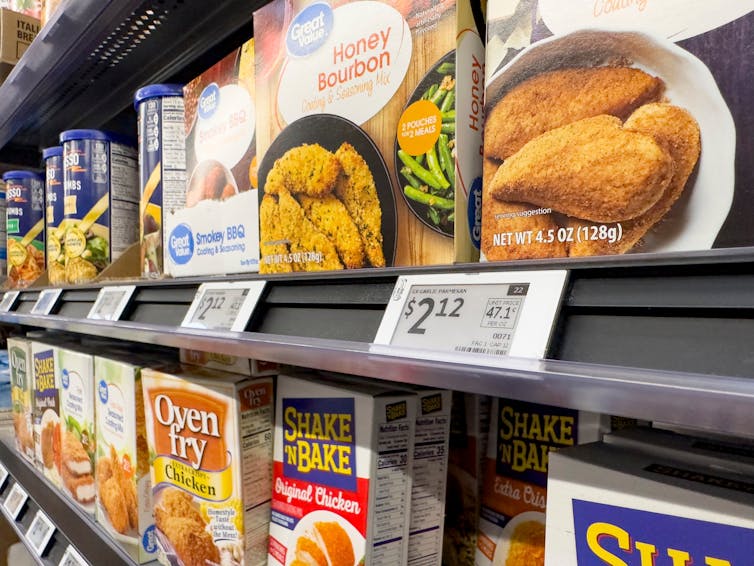 Electronic price labels on shelf of seasoning mixes in a grocery store