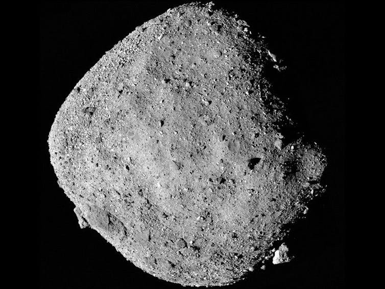 A dusty, rocky asteroid against a dark backdrop.