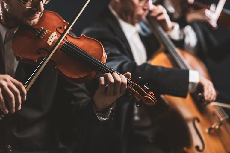 Professional symphonic string orchestra performing on stage