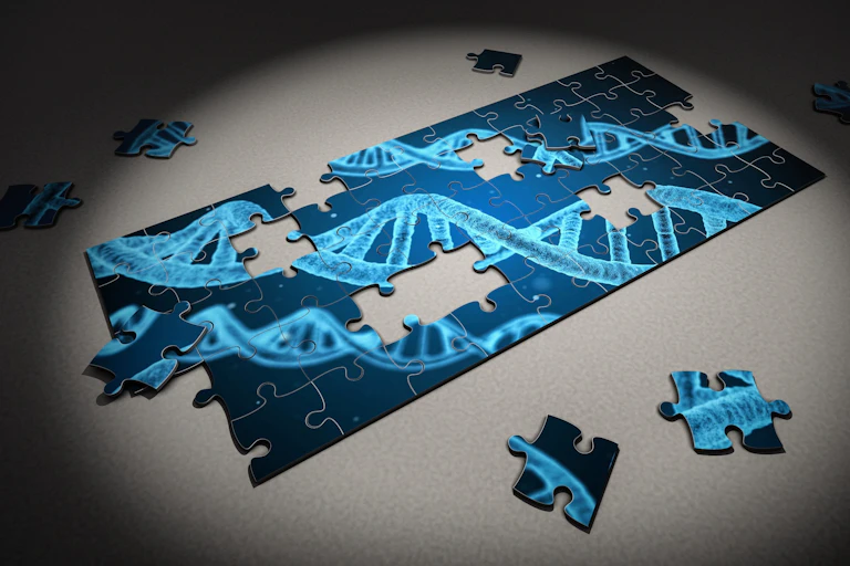 A jigsaw puzzle in progress picturing blue strands of DNA