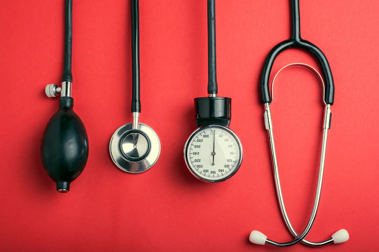 Medical tools against a red background.