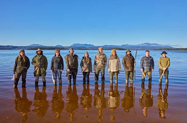 10 participants of Alone Australia 3 standing in Tasmanian waters