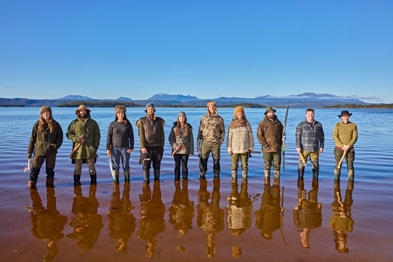 10 participants of Alone Australia 3 standing in Tasmanian waters