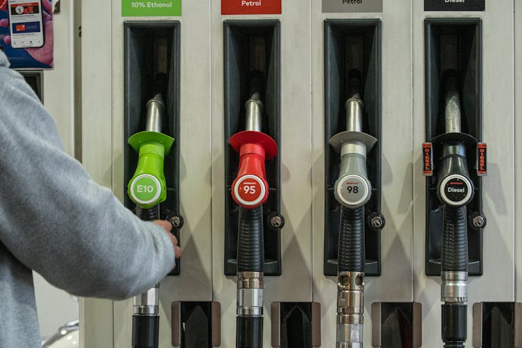 Man reaches for fuel pump