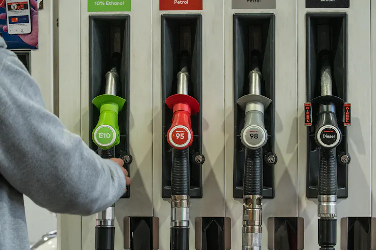 Man reaches for fuel pump