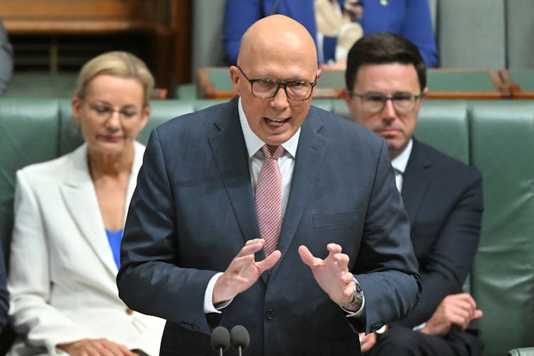 man gesturing during speech