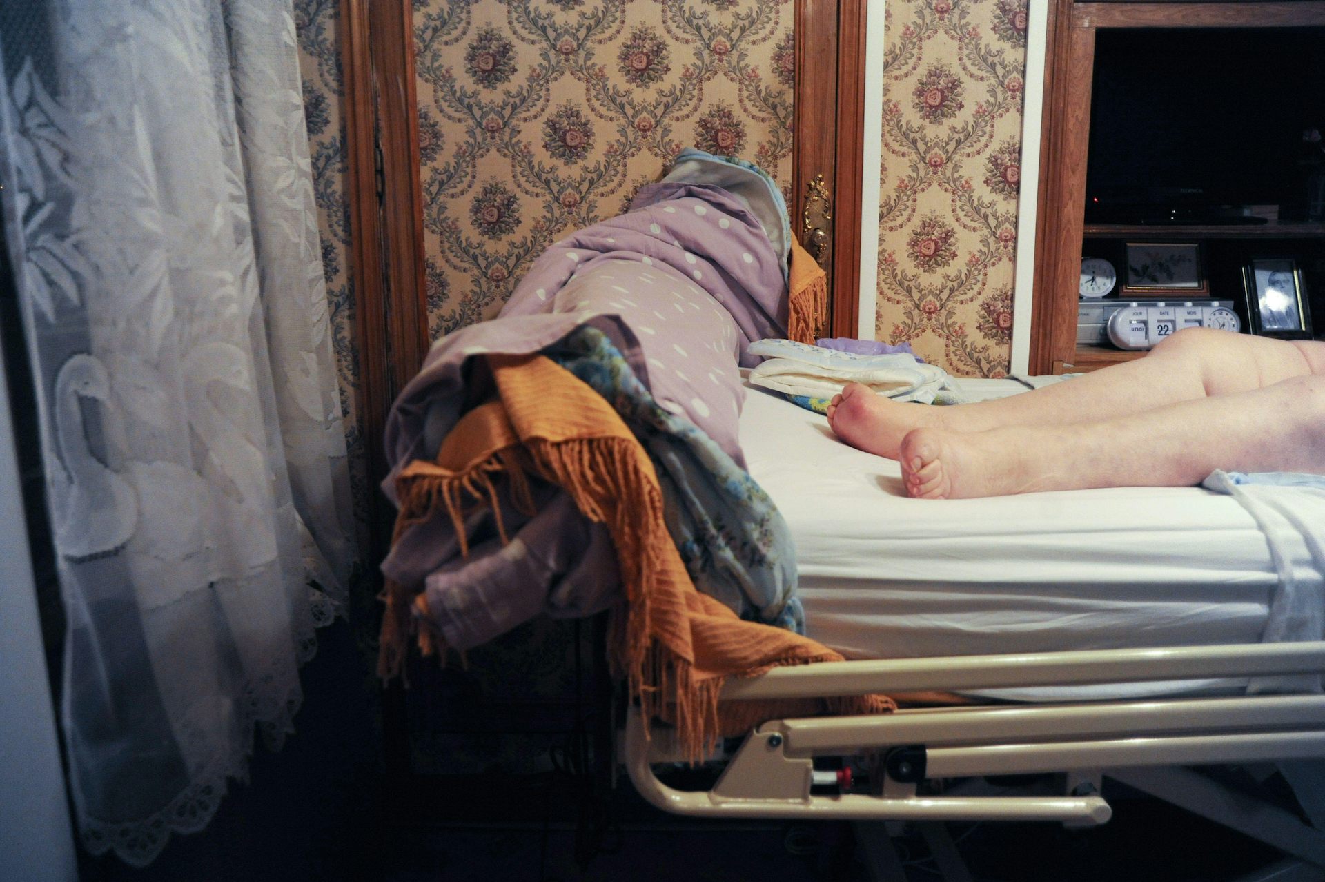 An elderly woman on a gantry at home.