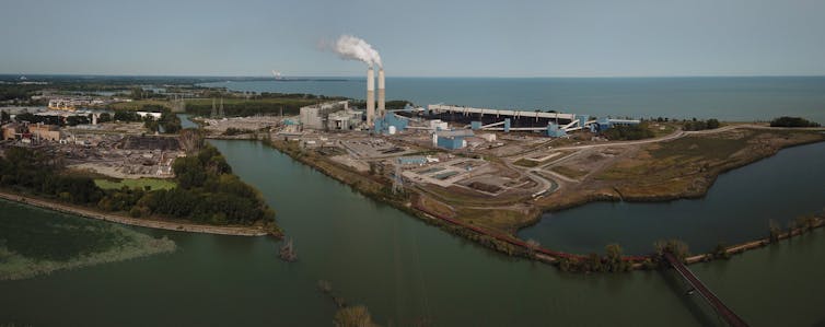 coal power plant on shore of large lake
