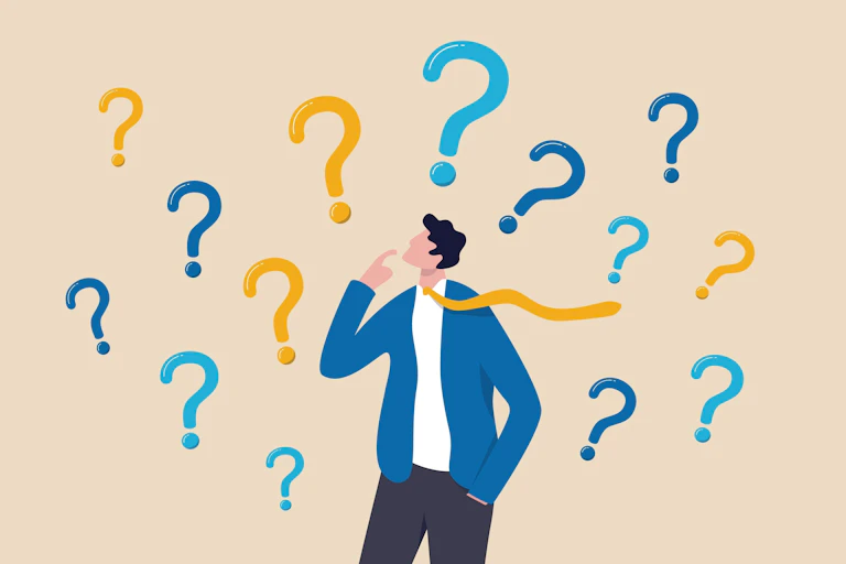 Confused man surrounded by question marks.