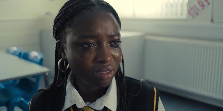 a young girl with tears on her face