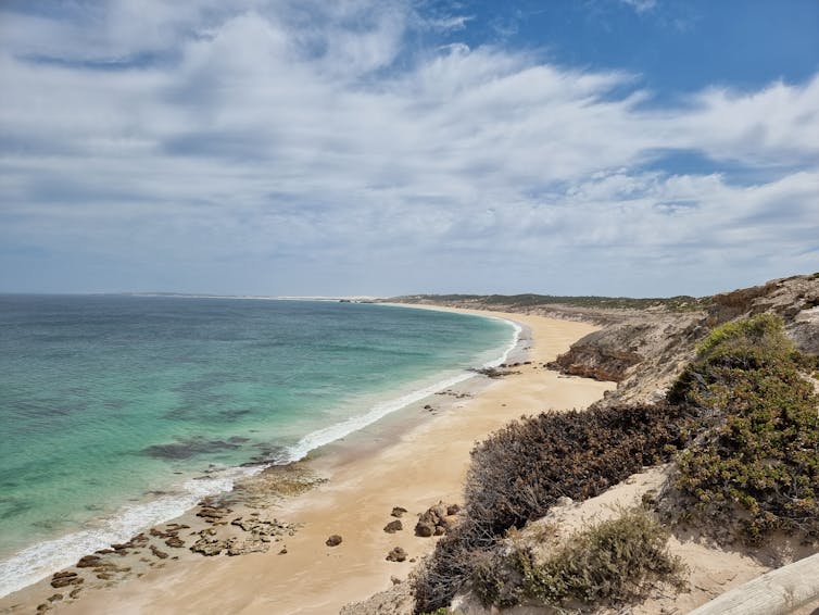 A beautiful sandy beach, as seen from the cliff top.