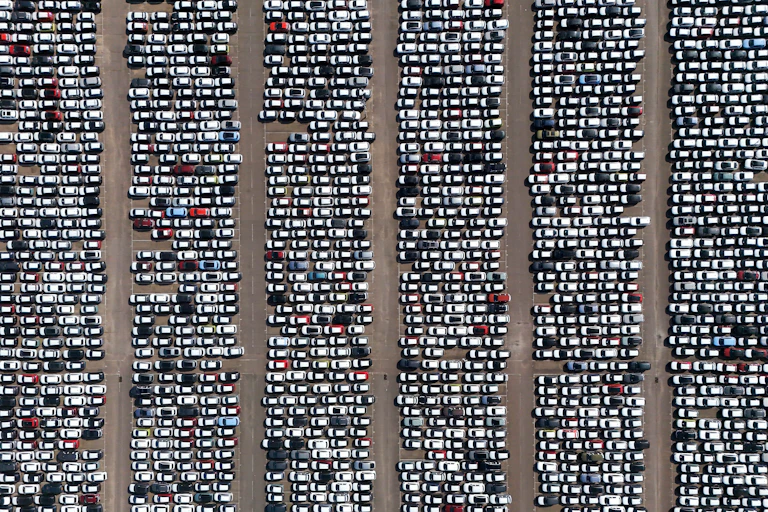 Aerial view of hundreds of parked cars.