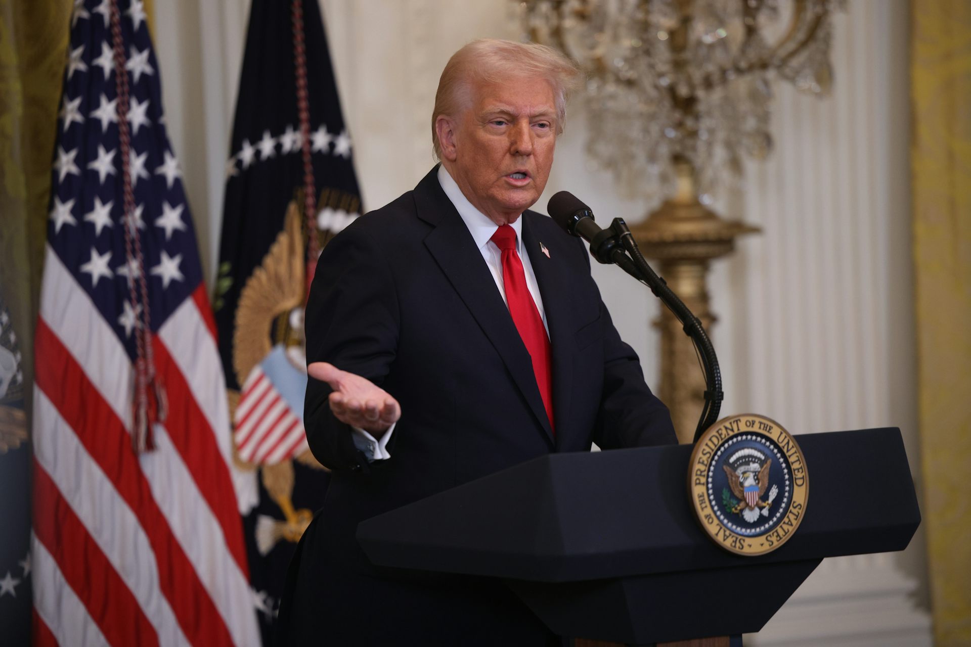 US President Donald Trump speaks at a lectern in the East Room of the White House, march 26 2025.